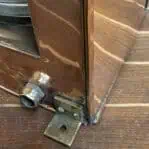Mounting leg and conduit detail on copper nautical masthead lantern