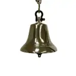 Side view of decorative brass bell with clapper attached