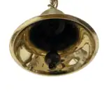 Underside view showing clapper of decorative brass bell