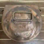 Top of copper light with HEKLIGHT marking