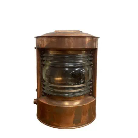 Front view of copper nautical running light with clear Fresnel lens