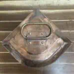 Top handle of copper navigation light with curved bracket detail