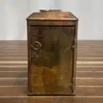 Back of copper navigation light with brass door and latch mechanism