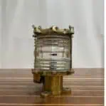 Side view of brass nautical deck light with marine patina and Fresnel lens