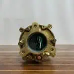Bottom view of salvaged marine light with mounting base and wiring