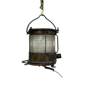 Brass weathered lantern front view showing Fresnel lens and brass guard bars