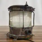 Brass weathered lantern rear view showing conduit opening and patina