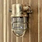 salvaged small bulkhead light with side conduits mounted showing side brass plugs
