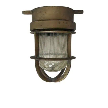 vintage brass ship light front view with cage and ribbed glass