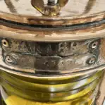Close-up of worn brass maker’s plate reading BAKDER 54349