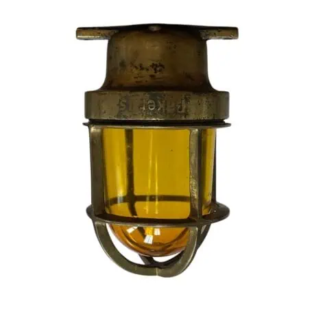 small brass baker ceiling light with amber glass front view cage and globe