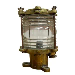Vintage brass post light front view with Fresnel glass lens and guard rods