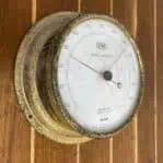 EIWA brass aneroid barometer front angled view with patina